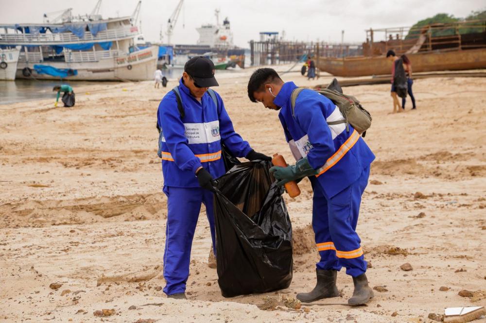 Garis da Terraplena colhem lixo em praia de Santarém. Foto: PMS